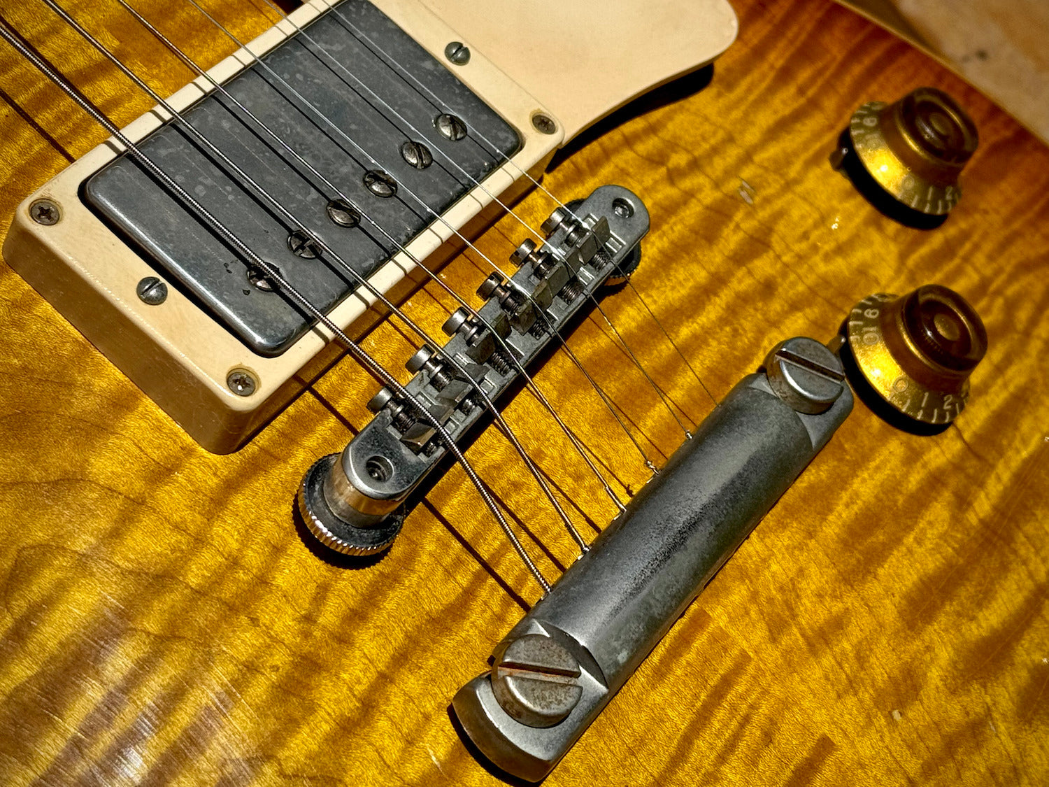 RDS Gibson Les Paul Electric guitar on a wooden bench with decorative metal backrest