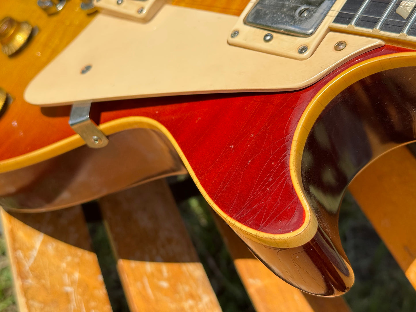 RDS Gibson Les Paul Electric guitar on a wooden bench with decorative metal backrest