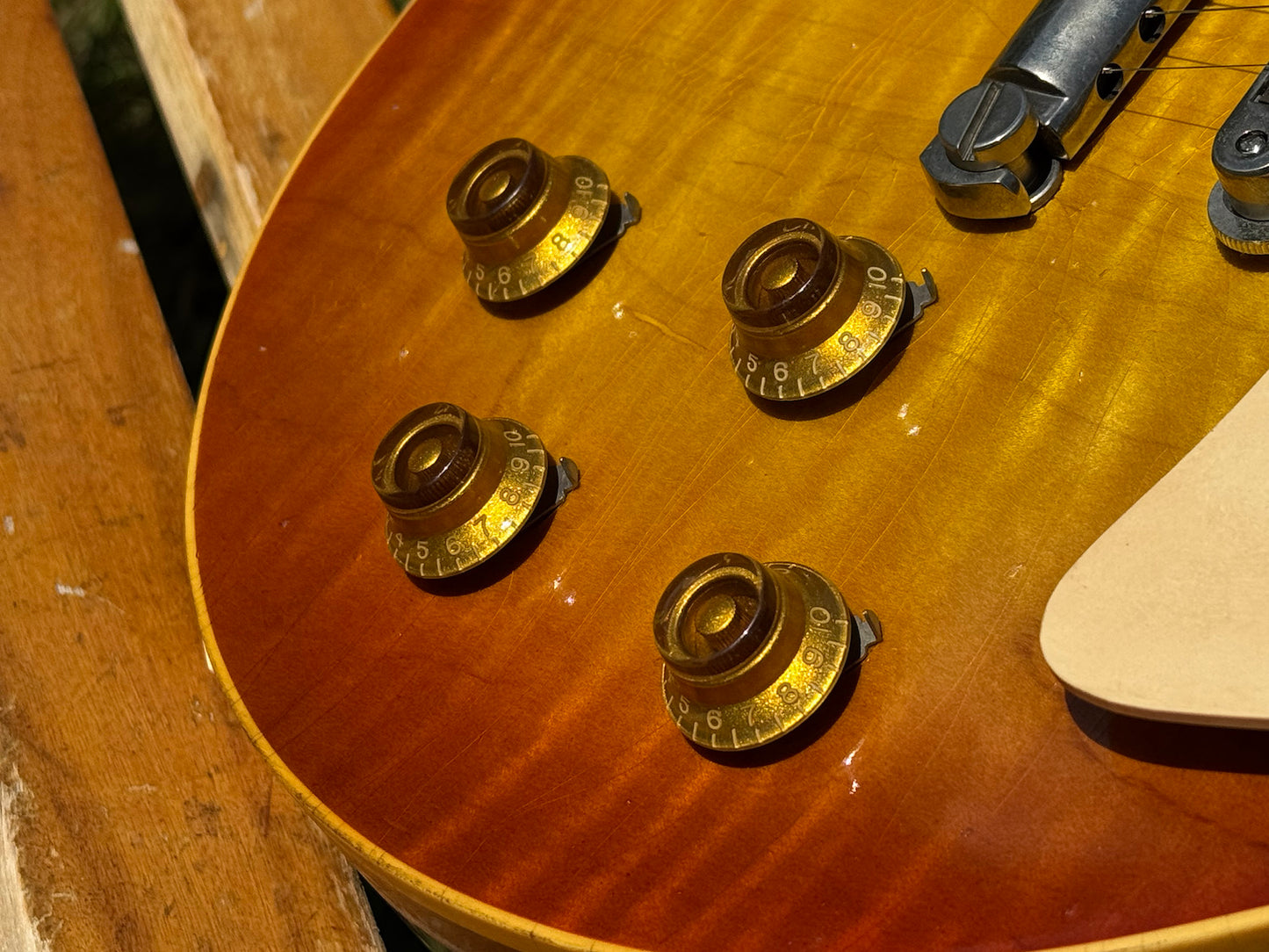 RDS Gibson Les Paul Electric guitar on a wooden bench with decorative metal backrest