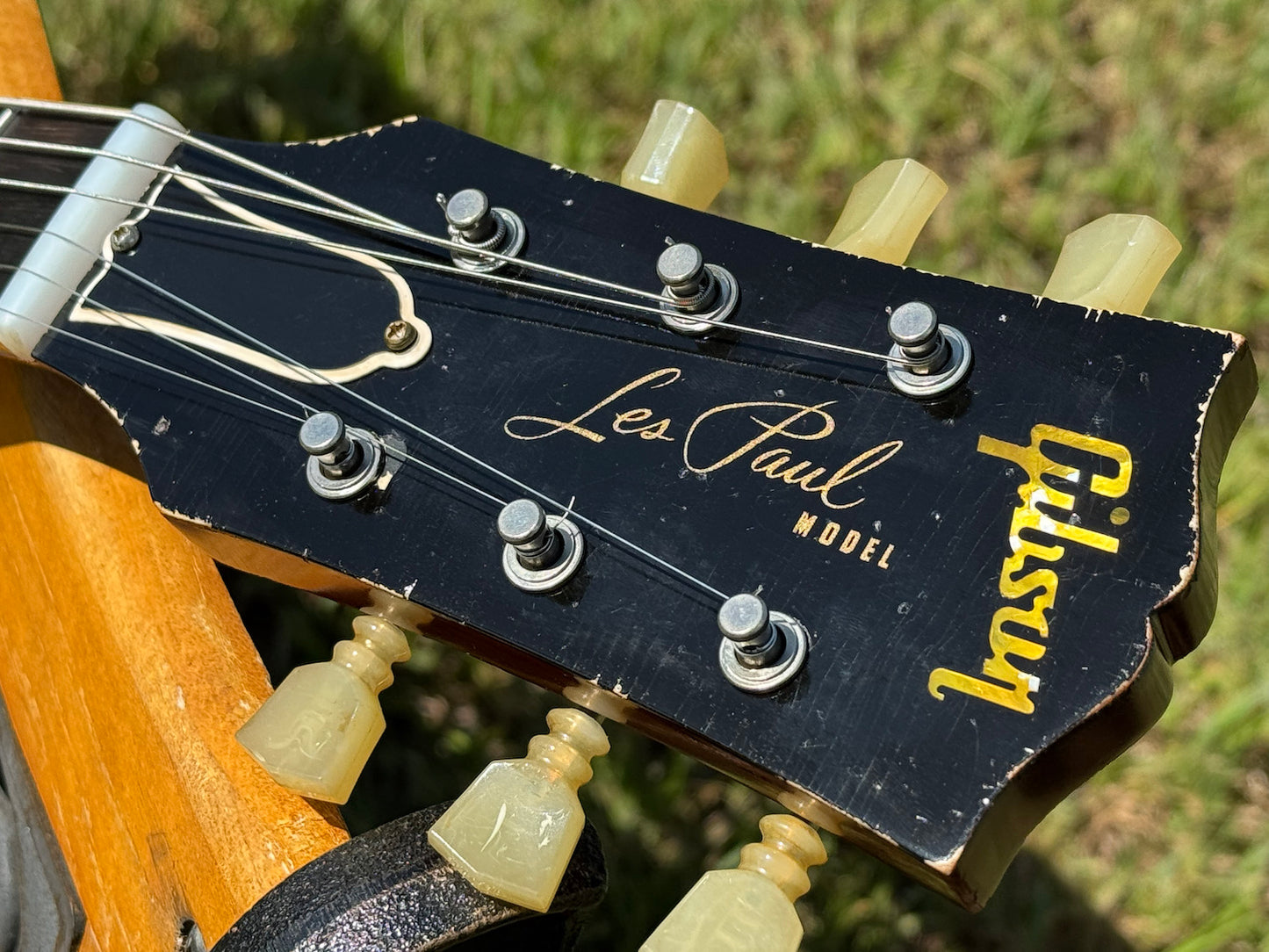 RDS Gibson Les Paul Electric guitar on a wooden bench with decorative metal backrest