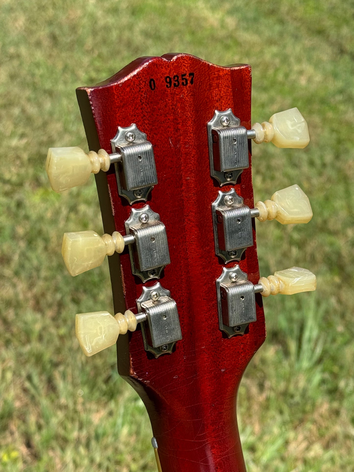 RDS Gibson Les Paul Electric guitar on a wooden bench with decorative metal backrest