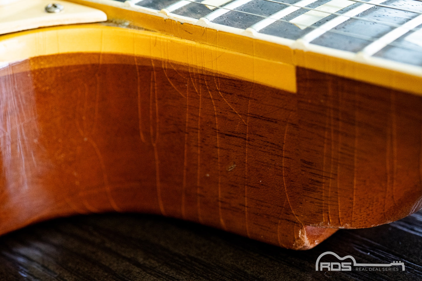 Close-up of a guitar's wooden neck and fretboard