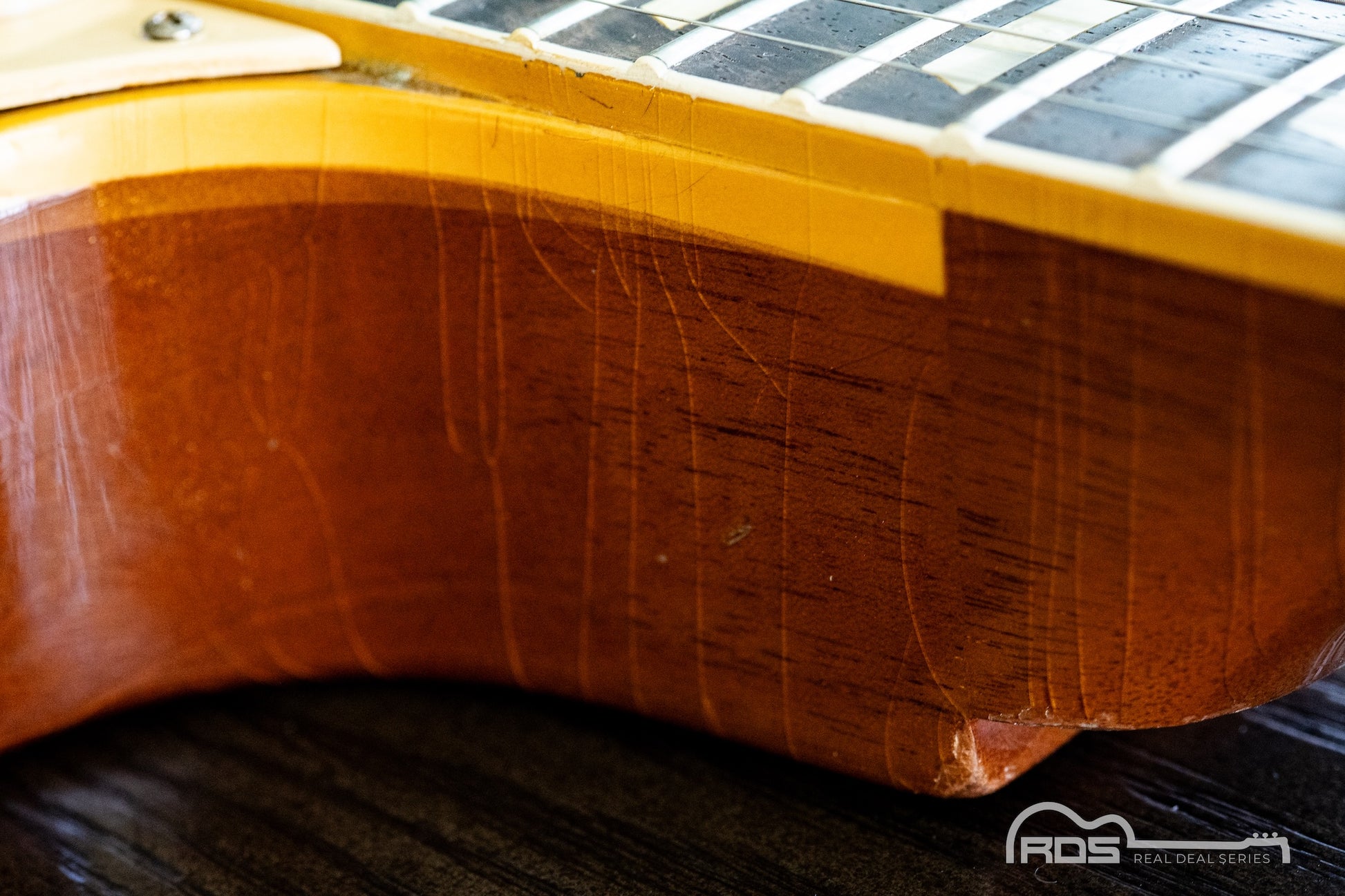Close-up of a guitar's wooden neck and fretboard