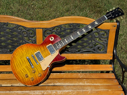 RDS Gibson Les Paul Electric guitar on a wooden bench with decorative metal backrest