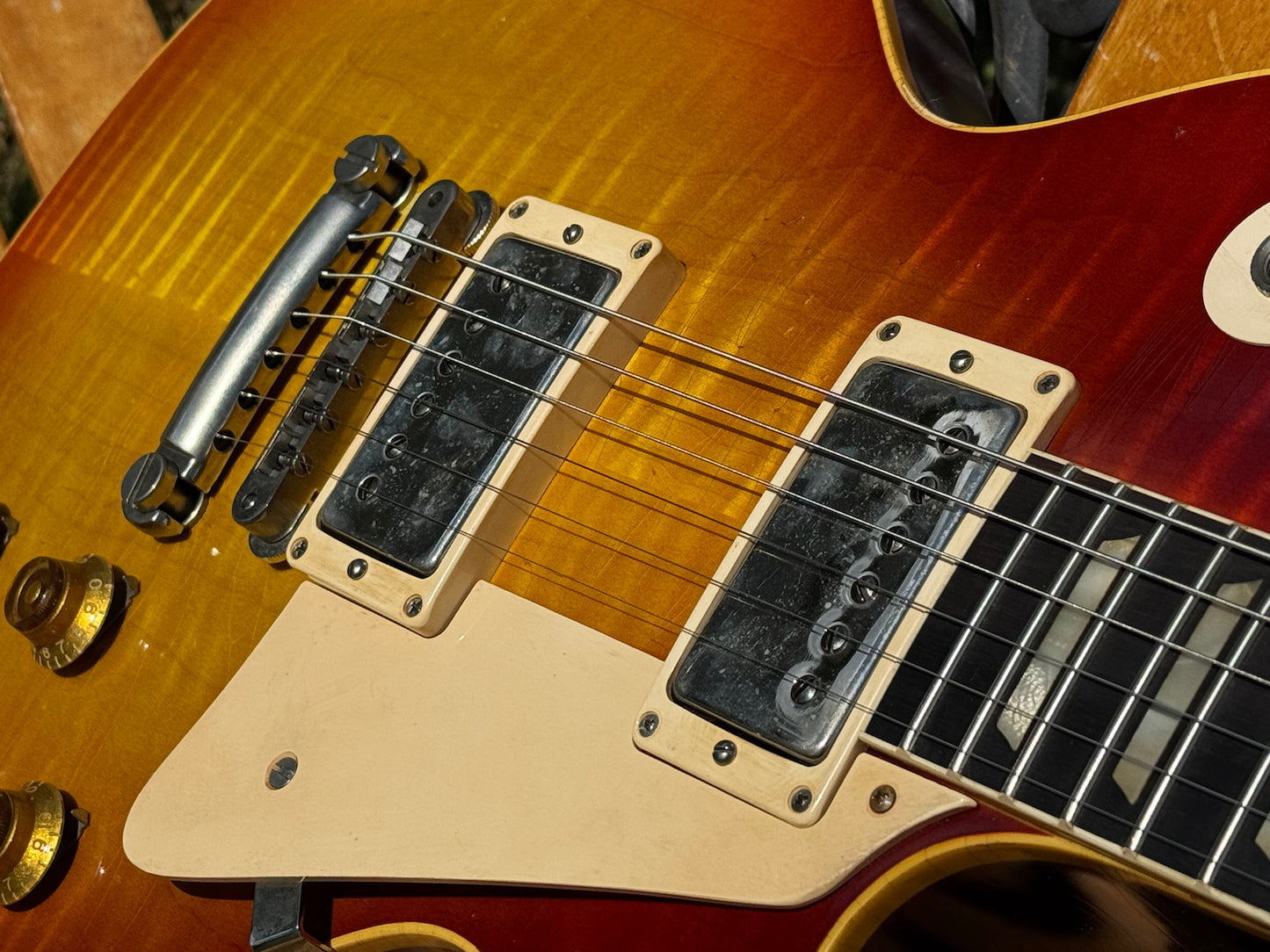 RDS Gibson Les Paul Electric guitar on a wooden bench with decorative metal backrest