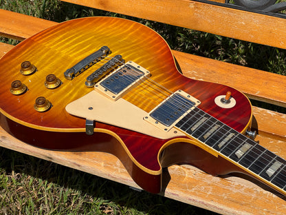 RDS Gibson Les Paul Electric guitar on a wooden bench with decorative metal backrest